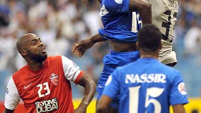 Al Ahli goalkeeper Saif Abdulla, right, grabs the ball in front of Al Hilal players during their Asian Champions League Group D match in Riyadh on February 26, 2014. Fayez Nureldine / AFP
