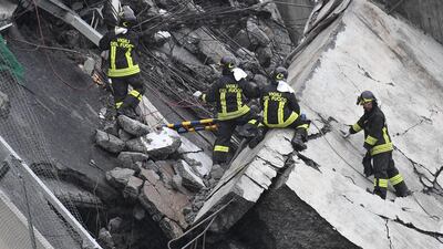 Rescuers at work amid the rubble. EPA