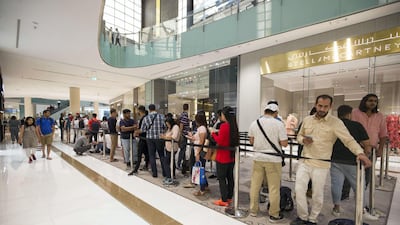 People queue to get the new iPhone XS at the Apple store in Dubai Mall. Leslie Pableo / The National