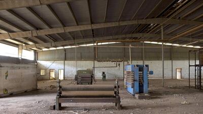 Broken machinery is seen at the defunct plywood company FOLBI in Buba. Joe Penney / Reuters