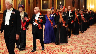 King Charles and Sultan Haitham are followed by Queen Camilla, Crown Prince Sayyid Theyazin bin Haitham and Prince William as they walk into the state banquet. AFP
