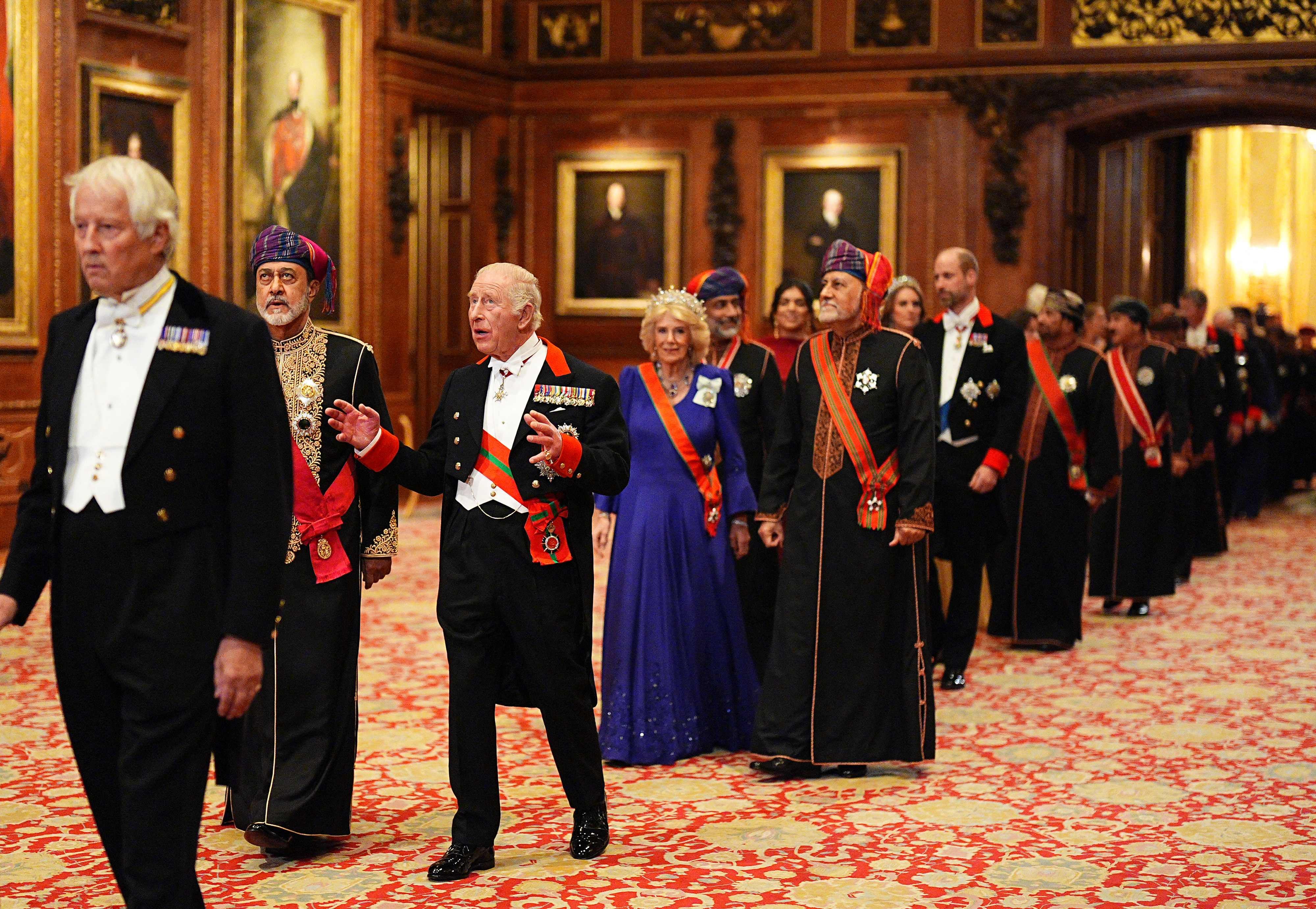 King Charles and Sultan Haitham are followed by Queen Camilla, Crown Prince Sayyid Theyazin bin Haitham and Prince William as they walk into the state banquet. AFP