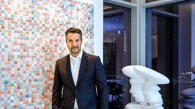 Art collector Mohammed Afkhami with his collection of Iranian Art at his home in Dubai. Left, and untitled painting by Charles Hossein Zenderoudi, and a sculpture by Sir Tony Cragg. Victor Besa for The National