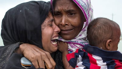 DAKHINPARA, BANGLADESH - SEPTEMBER 08: Rohingya Muslim refugees react after being re-united with each other after arriving on a boat from Myanmar on September 08, 2017 in Whaikhyang Bangladesh. Thousands of Rohingya continue to cross the border after violence erupted in Myanmar's Rakhine state when the country's security forces allegedly launched an operation against the Rohingya Muslim community. (Photo by Dan Kitwood/Getty Images) *** BESTPIX ***