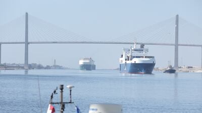 Container ships pass under the Suez Canal Bridge. A tugboat sank in the canal on Saturday after colliding with a Hong Kong-flagged tanker. Reuters