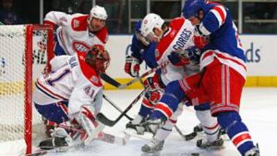 Goaltender Jaroslav Halak of the Montreal Canadiens denies Colton Orr of the New York Rangers.