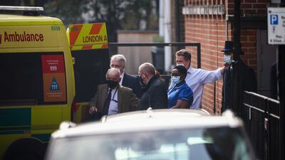 Hospital staff stand next to an ambulance outside King Edward VII's Hospital. Reuters