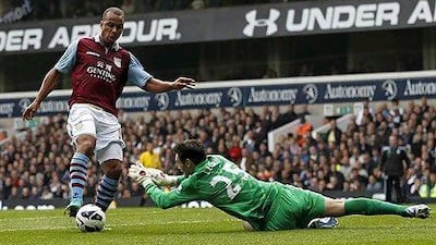 Tottenham Hotspur's French goalkeeper Hugo Lloris (R) dives at the feet of Aston Villa's English striker Gabriel Agbonlahor (L) during the English Premier League football match between Tottenham Hotspur and Aston Villa at White Hart Lane in north London, England on October 7, 2012. AFP PHOTO/IAN KINGTON