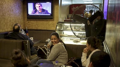 Egyptians watch the weekly programme of Bassem Youssef, the man known as “Egypt’s Jon Stewart,” at a coffee shop in Cairo. Khalil Hamra / AP
