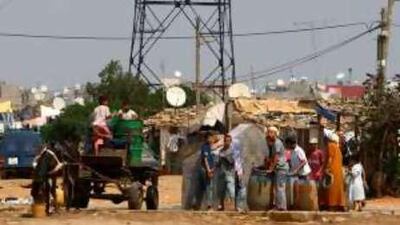 Children fill buckets with water in the Temara shanty town in Morocco. Union for the Mediterranean has vowed for education in the region.