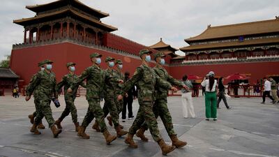 Security personnel march at the entrance of the Forbidden City in Beijing. AFP