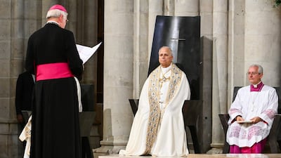 Pope Leo listens to the Archbishop of Paris, Laurent Ulrich, at Notre-Dame Cathedral. AFP
