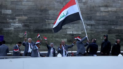 Members of the Iraqi team wave their flags. EPA