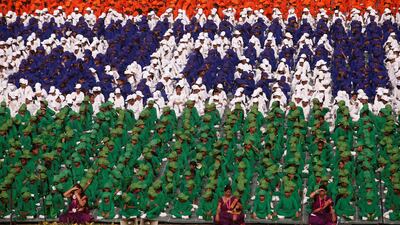 Schoolchildren listen as Mr Modi, not pictured, addresses the nation. Reuters
