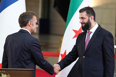 Ahmad Al Shara and Emmanuel Macron in Damascus on Tuesday. AFP