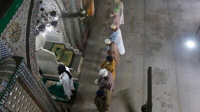 Friday prayers take place outside a mosque in Lahore, Pakistan, as a preventive measure against the spread of coronavirus infections AP