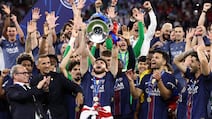 PSG players lift the trophy in Budapest. AFP