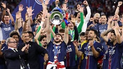 PSG players lift the trophy in Budapest. AFP
