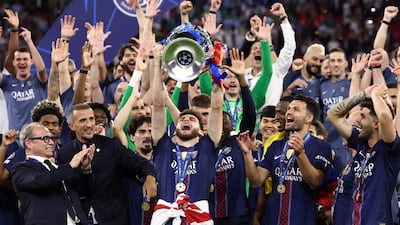 PSG players lift the trophy in Budapest. AFP