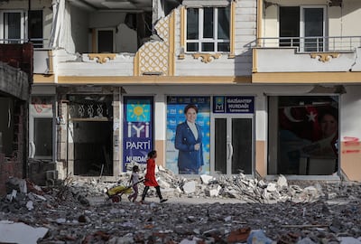 People walk in front of a picture of Turkish oppoisiton IYI Parti party leader Meral Aksener in Nurdagi district of Gaziantep, Turkey. EPA