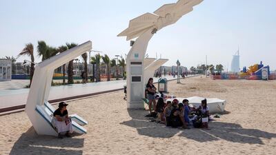 Beach-goers take in some shade on a sunny Sunday in Dubai. Antonie Robertson/The National