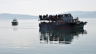 Migrants are escorted by the Turkish coastguard after being intercepted en route to Greece on the Aegean Sea. Getty Images