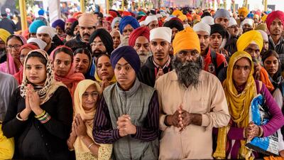 Sikh devotees pay their respects on the occasion of the 550th birth anniversary of Guru Nanak Dev at Gurudwara Ber Sahib in Sultanpur Lodhi on November 12, 2019. Sporting saffron and blue turbans and headscarves, hundreds of thousands of devotees braved smog to pack the city of Sultanpur Lodhi in India for the 550th birth celebrations of Sikhism's founder Guru Nanak. AFP