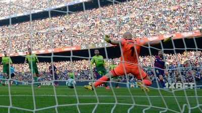 Eibar's Serbian goalkeeper Marko Dmitrovic fails to stop the ball kicked by Barcelona's Argentine forward Lionel Messi. AFP