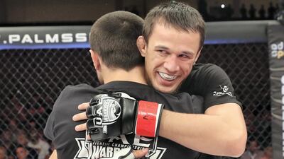 Usman Nurmagomedov (black gloves) celebrates his win against Roman Golovinov in the lightweight division. Chris Whiteoak / The National
