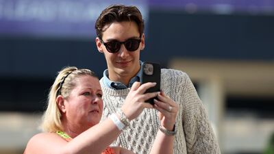 Mercedes driver George Russell with a fan at the Yas Marina Circuit