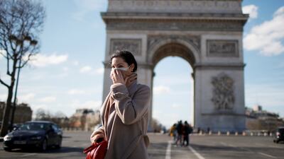 A woman walks near the Arc de Triomphe in Paris, France. Reuters