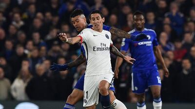 Chelsea fullback Kenedy, left, challenges Paris Saint-Germain midfielder Angel Di Maria. Ben Stansall / AFP