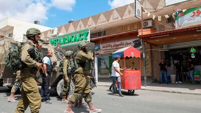 Israeli security forces conduct a search operation following a stabbing attack in the West Bank village of Azzun near Qalqilya. AFP