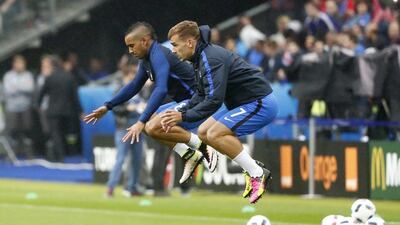 France forward Antoine Griezmann and midfielder Dimitri Payet warm up before the game. Christian Hartmann / Reuters