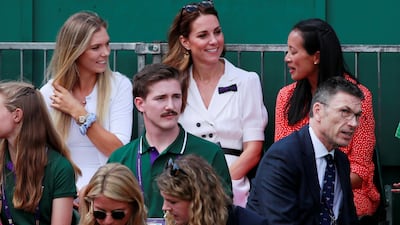 Kate Middleton, Duchess of Cambridge, sits with former British tennis player Anne Keothavong, right, and current player Katie Boulter during the first-round match between Britain's Harriet Dart and Christina McHale of the US. Reuters
