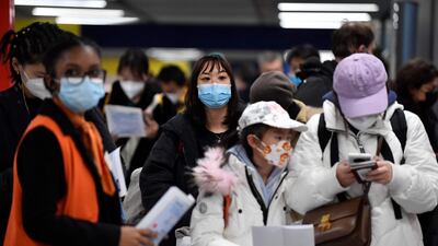 Passengers of a flight from China wait in a line for checking their Covid-19 vaccination documents in a Paris airport on New Year's Day. AFP