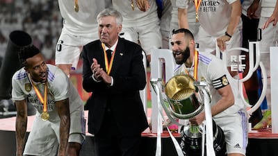 Eder Militao, Carlo Ancelotti and Karim Benzema celebrate with the Copa del Reey trophy. AFP