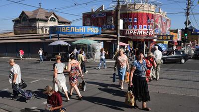 Ukranian people walk in a street of the key south-eastern port city of Mariupol, on September 6 after a ceasefire was signed on September 5 between Ukraine and pro-Kremlin insurgents. Philippe Desmazes / AFP