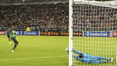 Goalkeeper Boubacar Barry of Ivory Coast, right, makes a save to give his team the edge against Ghana on Sunday in the Africa Cup of Nations final. Barry Aldworth / EPA