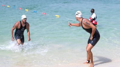 Athletes reach the finish line at the Special Olympics World Games open water swimming competition in La Mer. Reem Mohammed / The National