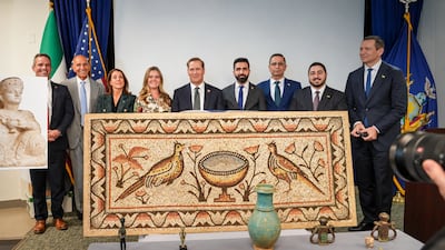 Syrian and American officials with a Roman mosaic that was returned by New York prosecutors Photo: Sana