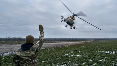 A Ukrainian soldier waves to a military helicopter returning from the combat, close to the frontline in the Kherson region this week. AP Photo