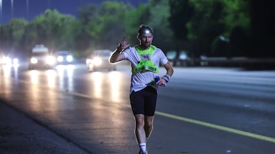 Former British soldier Harry Amos on the e11 motorway around the Al Faqa area of Abu Dhabi during his run across the seven emirates of the UAE in fewer than six days. Photos: Victor Besa / The National