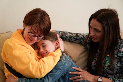 Ukrainian woman Kristina Korniiuk hugs Samantha Platings after being welcomed to the family home by Rend Platings, right. PA