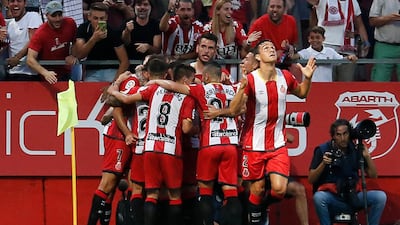 Girona's Uruguayan Cristhian Stuani celebrates with teammates after scoring against Atletico Madrid at the Montilivi Stadium in Girona on August 19, 2017. Pau Barrena / AFP