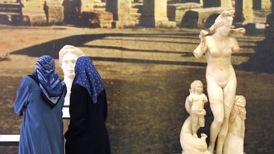 A file picture from March 5, 2002 shows Libyan women looking at Roman statues unearthed at the ancient city of Sabartha, some 67 kms west of Tripoli on display at the Saray Al Hamra, or Red House museum in the Libyan capital. Behrouz Mehri/AFP Photo
