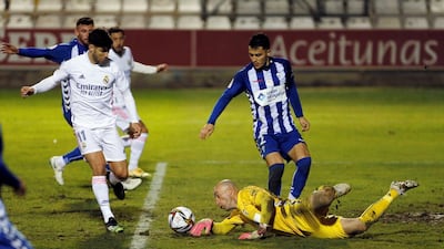 Alcoyano goalkeeper Jose Juan Figueiras saves a ball against Marco Asensio. EPA