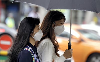 Tourists wear masks as a precaution against MERS (Middle East Respiratory Syndrome) at a shopping district in Seoul, South Korea in June 2015. (AP Photo/Lee Jin-man)