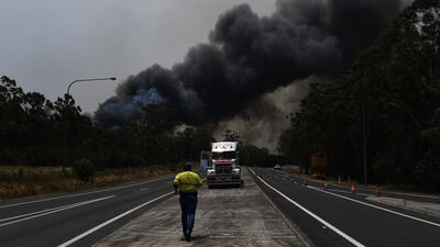 A truck driver prepares to move his vehicle through a roadblock bypass on the Princes Highway near the town of Sussex Inlet. Getty