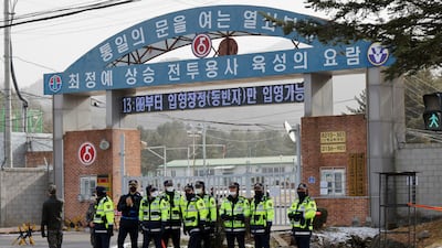 Police officers and soldiers stand guard outside an army boot camp near the demilitarised zone before the arrival of BTS member Jin in Yeoncheon, South Korea, on December 13. Reuters